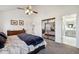 Main bedroom featuring a large bed, mirrored closet and ensuite bathroom at 8293 S Ogden Cir, Littleton, CO 80122