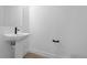 Modern powder room featuring a pedestal sink, sleek faucet, and minimalist design at 14281 Currant St, Broomfield, CO 80020