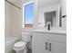 Modern bathroom with shower-tub combo, vanity, and large window at 14281 Currant St, Broomfield, CO 80020