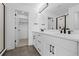 Stylish bathroom with double sinks, walk-in closet access, and modern fixtures at 14281 Currant St, Broomfield, CO 80020