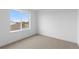 Bright bedroom features neutral carpet, white walls and trim, and a large window with a view at 14281 Currant St, Broomfield, CO 80020