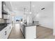 Open concept kitchen with large island, stainless appliances, and adjacent dining area at 14281 Currant St, Broomfield, CO 80020