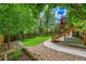 Landscaped backyard featuring a well-maintained lawn, stone patio, and wooden fence for privacy at 1795 Eldorado Cir, Superior, CO 80027