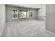 Basement with carpeted floors and three large windows overlooking a wooded area at 1795 Eldorado Cir, Superior, CO 80027