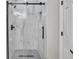 This bathroom features a frameless shower with marble-look tile and black hardware at 1795 Eldorado Cir, Superior, CO 80027
