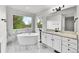 Modern bathroom featuring a soaking tub, granite countertops, and marble flooring at 1795 Eldorado Cir, Superior, CO 80027