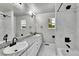 Bright bathroom with dual sinks, granite counters, and tub with marble surround at 1795 Eldorado Cir, Superior, CO 80027