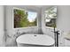 Bathroom features a luxurious soaking tub with a beautiful nature view at 1795 Eldorado Cir, Superior, CO 80027