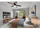 Bedroom with large window and furnished with a bed, sitting area, and television at 1795 Eldorado Cir, Superior, CO 80027