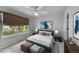 Bedroom with a large window, fan and a bed with a blue headboard at 1795 Eldorado Cir, Superior, CO 80027