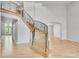 Elegant foyer featuring a curved staircase with wrought iron railings and hardwood floors at 1795 Eldorado Cir, Superior, CO 80027