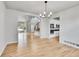 Bright living room with hardwood floors, modern light fixture, and open floor plan to the kitchen at 1795 Eldorado Cir, Superior, CO 80027