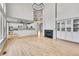Open-concept living room with kitchen, fireplace, hardwood floors, and natural light at 1795 Eldorado Cir, Superior, CO 80027