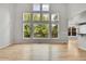 Sunlit living room with hardwood floors and a wall of windows showcasing the exterior at 1795 Eldorado Cir, Superior, CO 80027