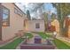 Inviting backyard patio area featuring lush faux lawn and comfortable outdoor seating at 621 Kearney St, Denver, CO 80220