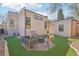Cozy backyard with faux grass, stone patio, and seating, perfect for outdoor relaxation at 621 Kearney St, Denver, CO 80220