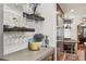 This bar area features a wine cooler, decorative shelving, and a nearby breakfast nook at 621 Kearney St, Denver, CO 80220
