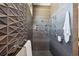 Modern bathroom featuring a shower with unique tiles, shower products, and metal fixtures at 621 Kearney St, Denver, CO 80220