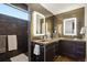 Modern bathroom with a floating vanity, illuminated mirrors, and sleek fixtures at 621 Kearney St, Denver, CO 80220