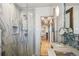 Bathroom featuring a glass enclosed shower, mosaic flooring, and updated vanity at 621 Kearney St, Denver, CO 80220