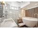 Elegant bathroom with a freestanding tub, glass shower, marble tiles, and modern fixtures for a spa-like experience at 621 Kearney St, Denver, CO 80220