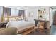 Bedroom with hardwood floors, desk, shelving and a comfortable queen sized bed at 621 Kearney St, Denver, CO 80220