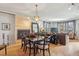 Open dining room with a fireplace, pendant lighting, and views into the living room at 621 Kearney St, Denver, CO 80220