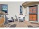 Inviting front patio with comfortable seating, stone pillars, and a secure decorative entrance door at 621 Kearney St, Denver, CO 80220