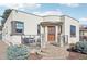 Charming home featuring a decorative security door, stone accents, and inviting front patio area at 621 Kearney St, Denver, CO 80220