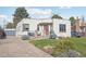 Inviting single-story home with a well-manicured lawn and charming curb appeal, featuring a paved driveway at 621 Kearney St, Denver, CO 80220