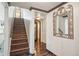 Hallway with wood stairs, decorative art, and dark hardwood flooring at 621 Kearney St, Denver, CO 80220