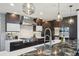 Modern kitchen with dark wood cabinets, stainless steel appliances, and large island with unique stone countertop at 621 Kearney St, Denver, CO 80220