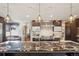 Spacious kitchen with stone countertop island, stainless steel appliances and ample natural light at 621 Kearney St, Denver, CO 80220