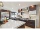 Open kitchen design featuring an island, dark wood cabinetry, breakfast nook, and stainless steel appliances at 621 Kearney St, Denver, CO 80220
