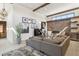 Spacious living room with stone fireplace, wooden beam, and comfortable seating at 621 Kearney St, Denver, CO 80220