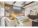 Main bedroom featuring a ceiling fan, two large windows and a relaxing sitting area at 621 Kearney St, Denver, CO 80220