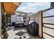 Private outdoor patio with a seating area, barbecue grill, and partial covering to enjoy outdoor living and entertaining at 621 Kearney St, Denver, CO 80220