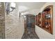Inviting wine cellar with stone walls, tile flooring, and decorative lighting fixtures adds a touch of old-world charm at 621 Kearney St, Denver, CO 80220