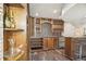 Custom wine cellar with wood cabinetry, built-in racks, a granite countertop, and a beverage refrigerator at 621 Kearney St, Denver, CO 80220