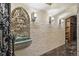 Stunning wine cellar hallway featuring a stone fountain, accent lighting, and access to the main wine storage area at 621 Kearney St, Denver, CO 80220