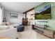 Open living room with wood beam accents and a cozy wood stove at 4700 S Decatur St, Englewood, CO 80110