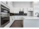 Modern kitchen with white cabinets, stainless steel appliances, and sleek countertops at 3801 Freestone Pt, Castle Rock, CO 80108