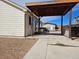 Back patio with wooden gazebo and concrete slab in fenced backyard with gravel ground cover at 808 Idalia St, Aurora, CO 80011