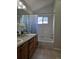 Bathroom featuring a double sink vanity, tiled floors, and shower-tub combination, designed for comfort and convenience at 808 Idalia St, Aurora, CO 80011