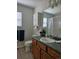 Well-lit bathroom with a white cabinet above the toilet and a shower with white tiling at 808 Idalia St, Aurora, CO 80011