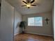 Cozy bedroom with wood-look flooring, a window, and simple decor at 808 Idalia St, Aurora, CO 80011