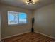 Comfortable bedroom with a window offering natural light, hardwood floors, and a contemporary ceiling light fixture at 808 Idalia St, Aurora, CO 80011