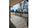 Inviting front porch with wood flooring and railing at 808 Idalia St, Aurora, CO 80011