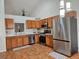 Bright kitchen with stainless steel appliances, including a large refrigerator, and ample wood cabinetry at 808 Idalia St, Aurora, CO 80011