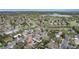 Aerial view of a tranquil neighborhood featuring mature trees, a nearby lake, and green spaces at 11398 W Ford Pl, Lakewood, CO 80226